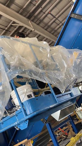 Professional spray foam equipment staged in a warehouse — the kind of operational backbone a franchise system should provide its operators.